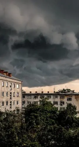 Amazing dark stormy tornado clouds over the apartment building in the city