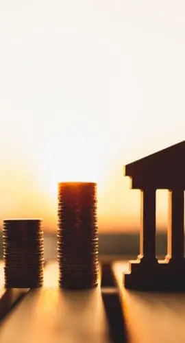 Bank symbol with with coins stack. Concepts of the banking system, rising interest rates, inflation, deflation, and savings.