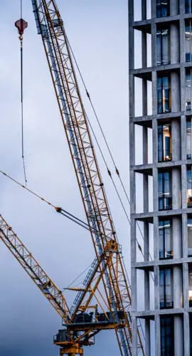 Construction tower cranes on a building site