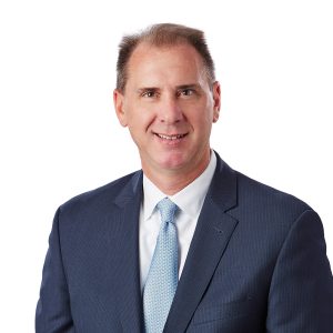 A person is wearing a suit and tie with a white shirt, offering a professional appearance.