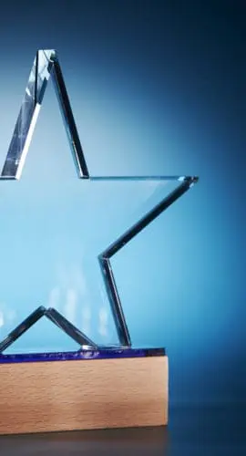 crystal star shape trophy against blue background