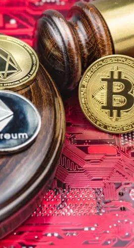 Different cryptocurrencies and gavel over computer mainboard.Concept image for cryptocurrency