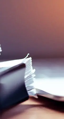 Stack of papers in front of computer