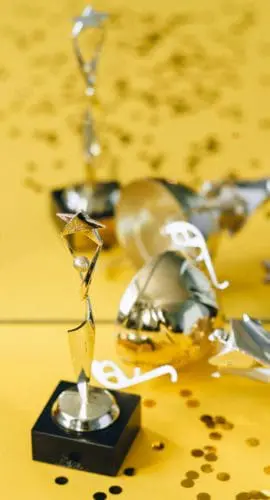 Golden statuette and trophy beside mirror