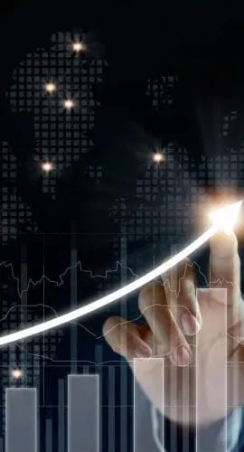 A hand is interacting with a digital graph that overlays a map, symbolizing financial or data trends on a global scale.