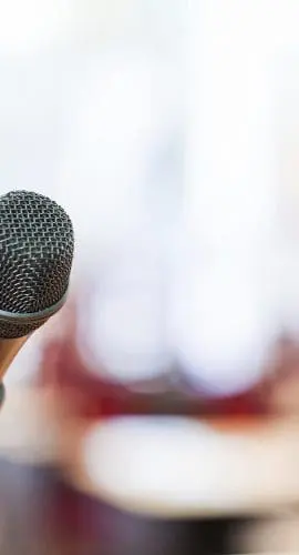 Close-up of a microphone at a government meeting, symbolizing public hearings and municipal legal services.