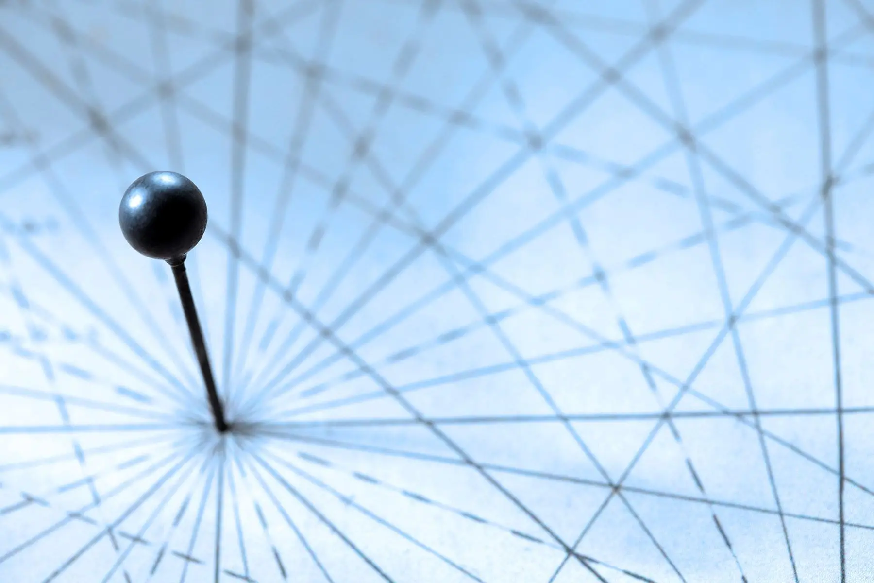 A pinpoint on a geometric diagram with lines radiating from the center.