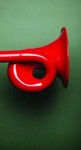 A red megaphone is held close to a person's ear against a green background.