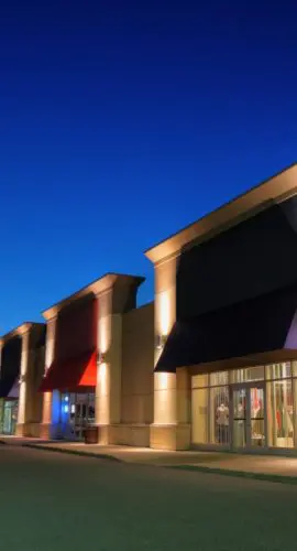 Retail shopping center with custom-built storefronts, representing reverse built-to-suit real estate transactions for investors and landlords