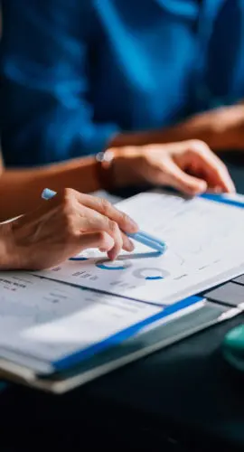 Handshake over commercial real estate loan documents, illustrating special purpose entity (SPE) carveouts and non-recourse loan terms for lenders and borrowers.